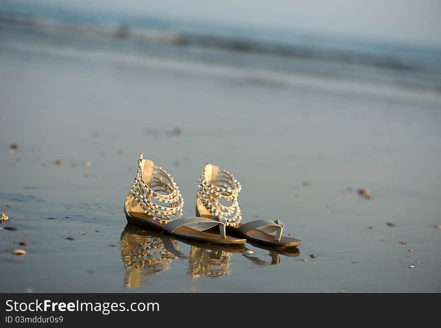 Shoes are relaxing in the water on the beach