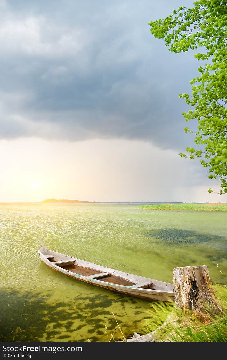 Boat at coast against a coming nearer thunder-storm