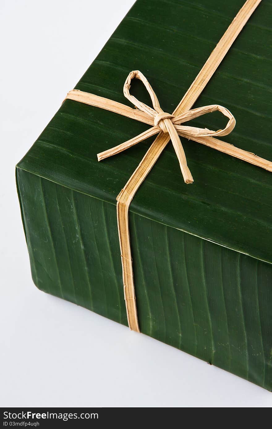 Gift box wrapped with banana leaf, ribbon and rope made from banana bark. Gift box wrapped with banana leaf, ribbon and rope made from banana bark.