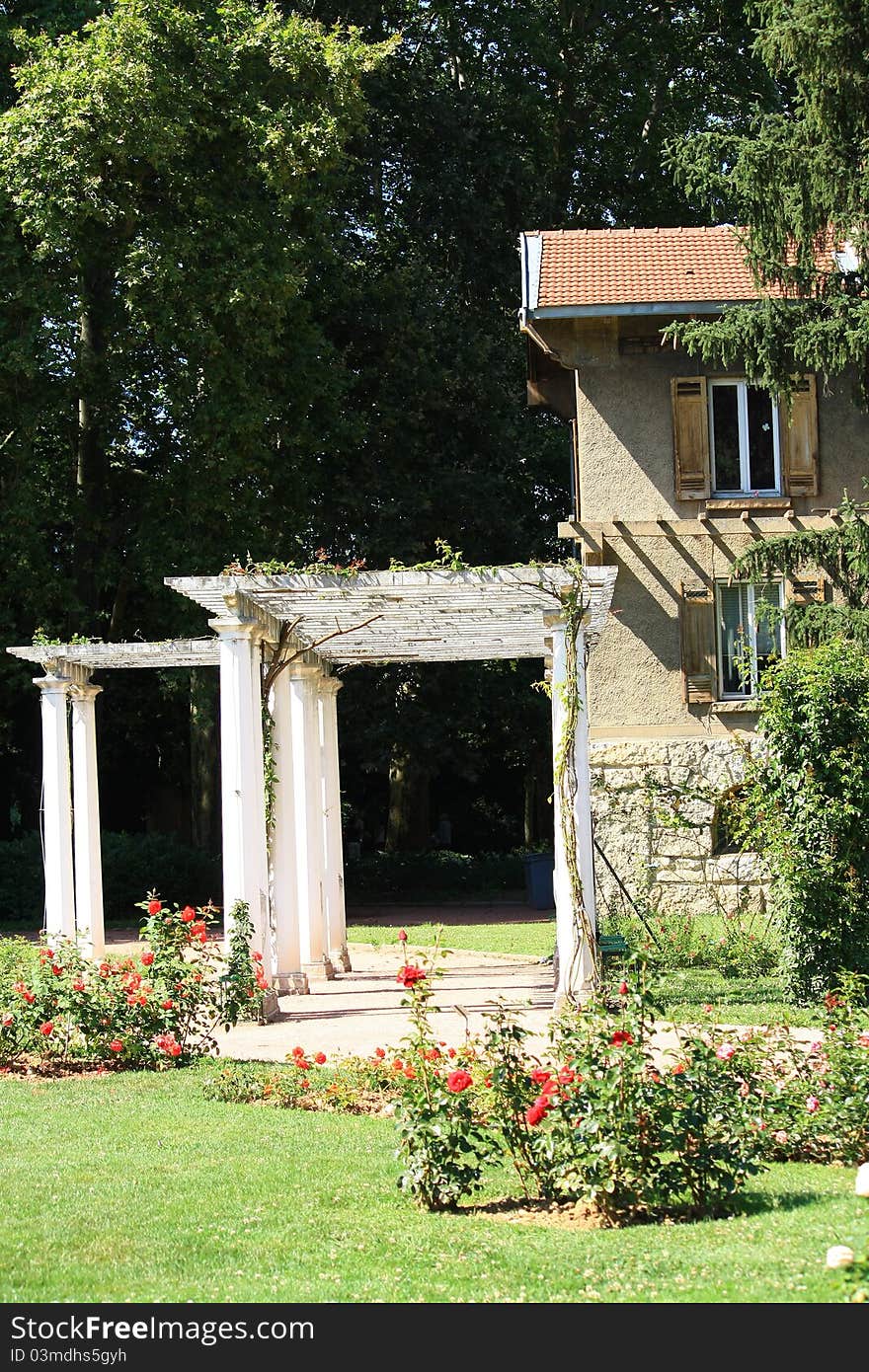 Beautiful old house with porgola in rose garden.