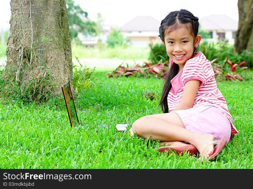 Girl with a laptop in the garden