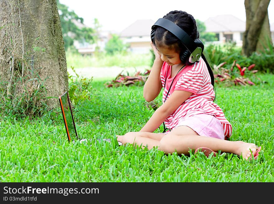 Girl listening to music. From a notebook in the garden. Girl listening to music. From a notebook in the garden