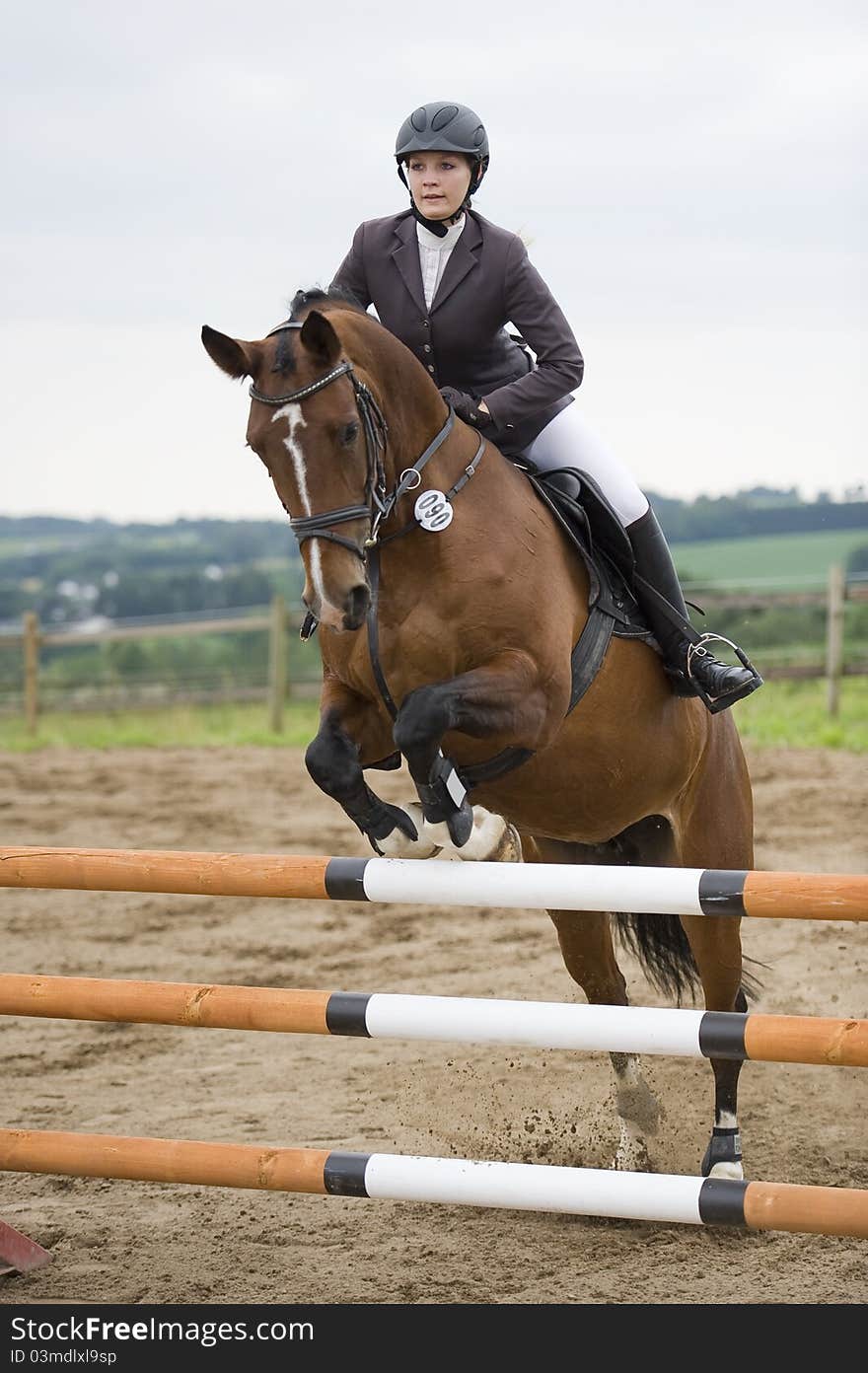 A woman is riding her horse