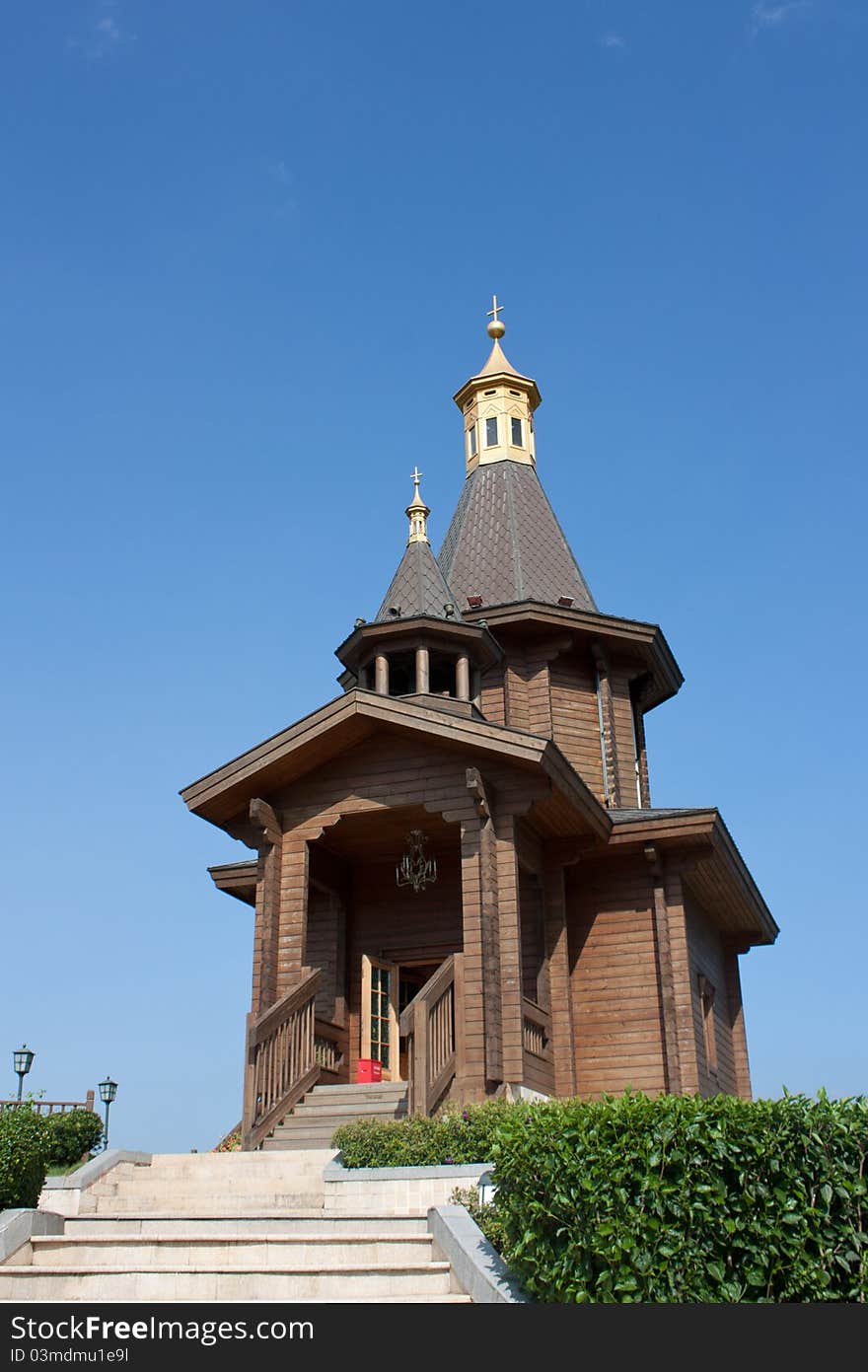 Small wooden church with golden rooftop