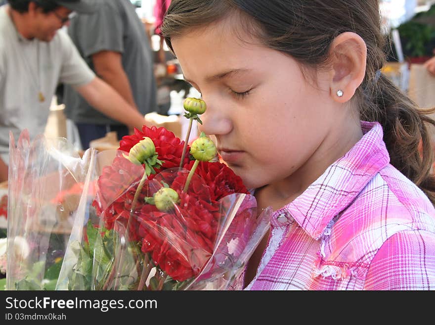 Girl Smelling Flowers