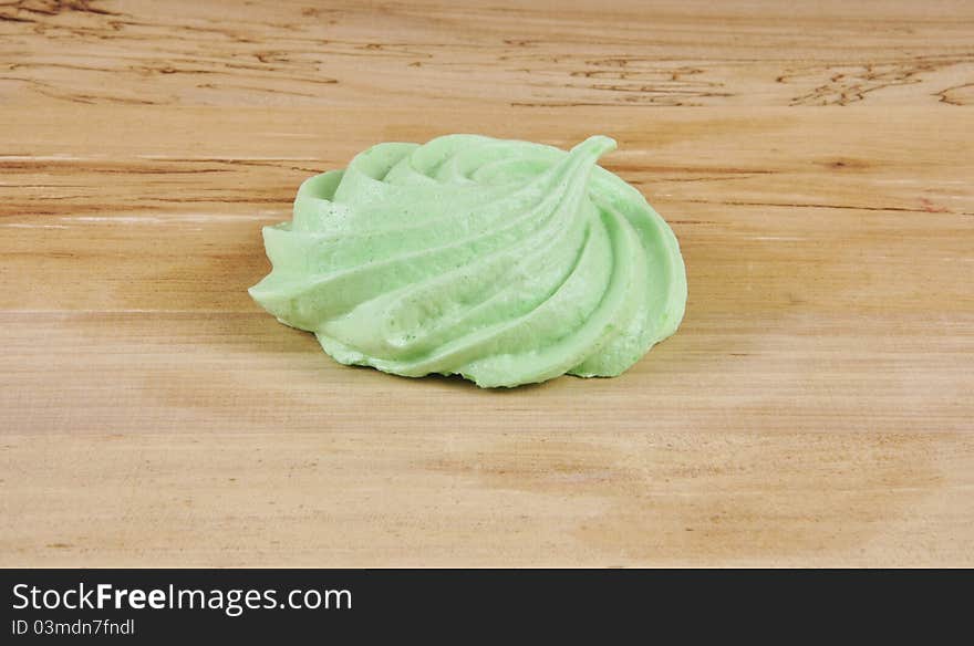 A green Meringue on a kitchen table. A green Meringue on a kitchen table.