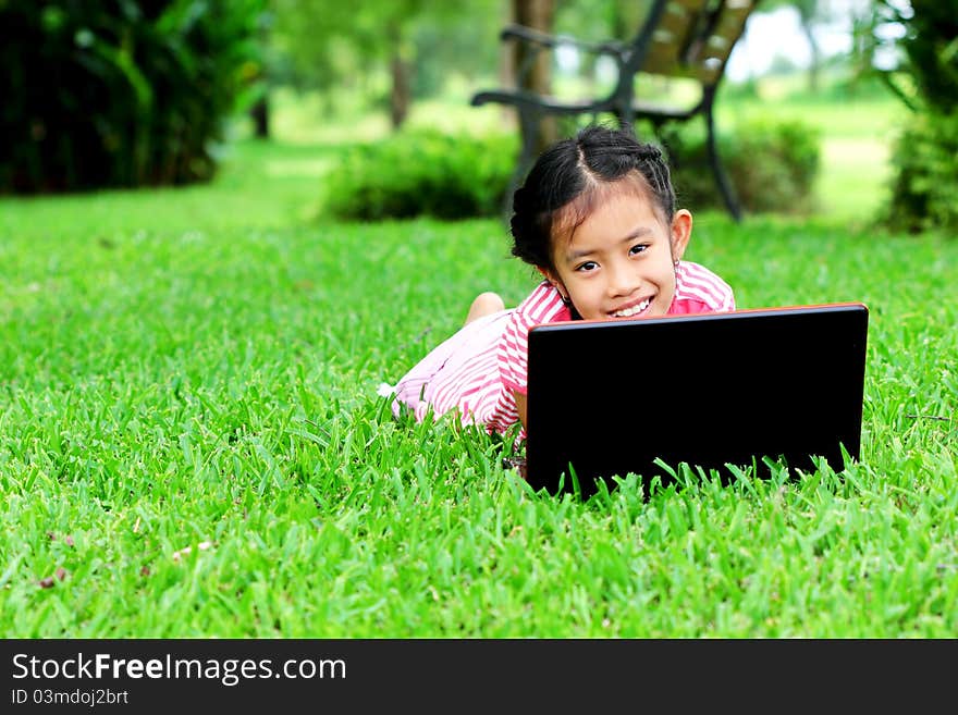 Girl with laptop in the park outside the home. Girl with laptop in the park outside the home