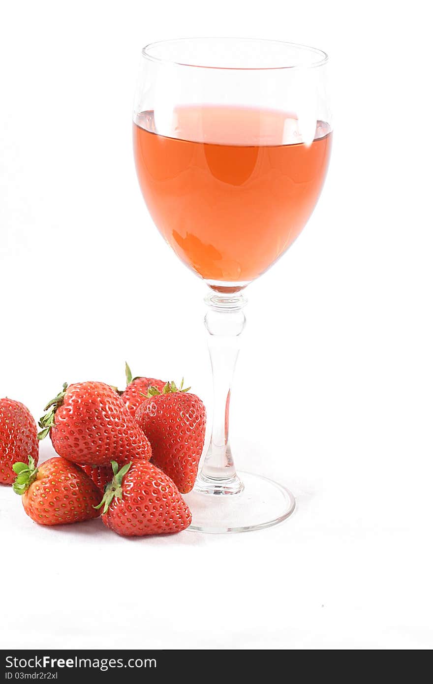 A Glass of pink wine and fresh strawberries. A Glass of pink wine and fresh strawberries.