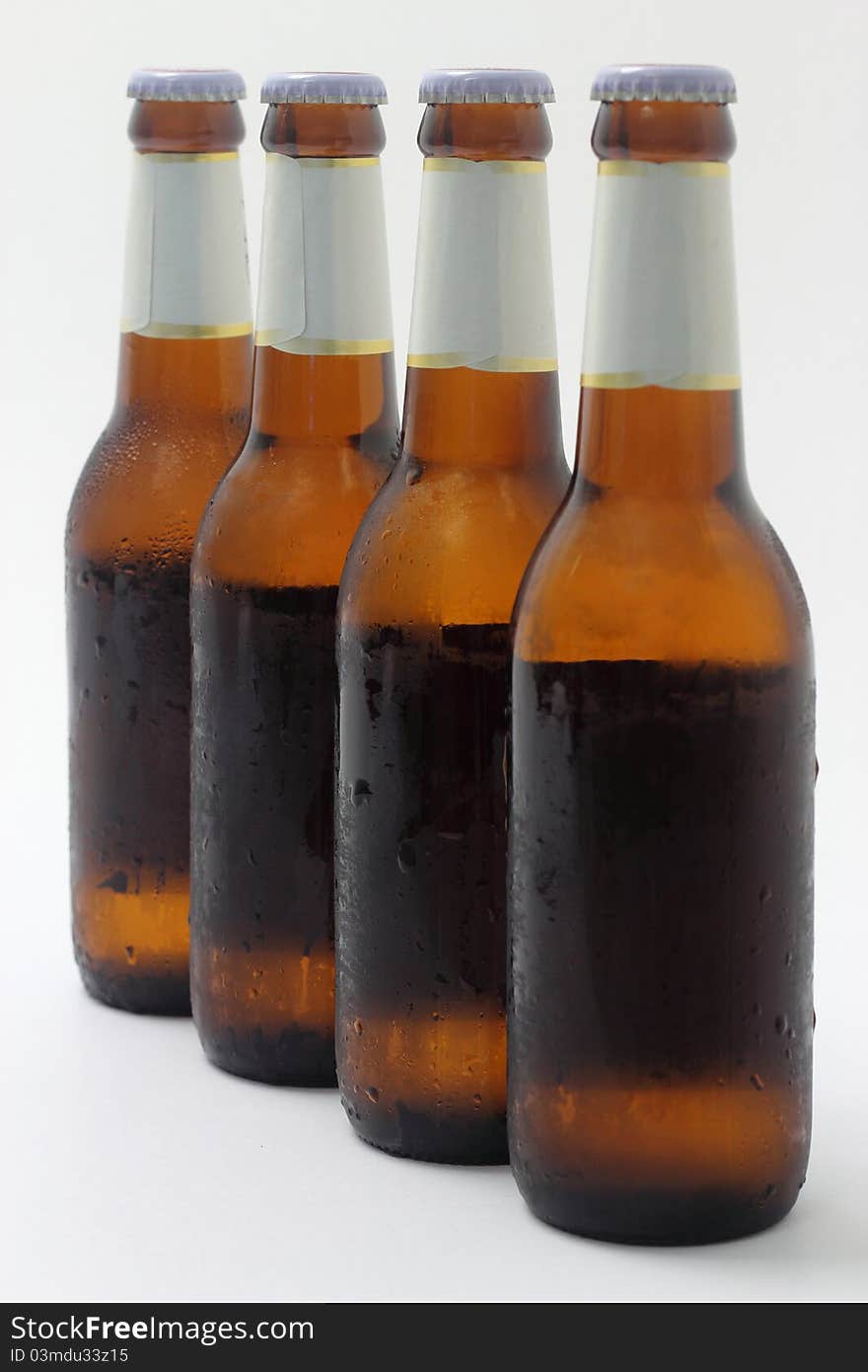 Four bottles of beer on white background