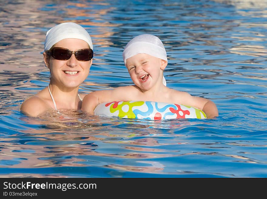 Baby With Mother Are Swimming In Pool