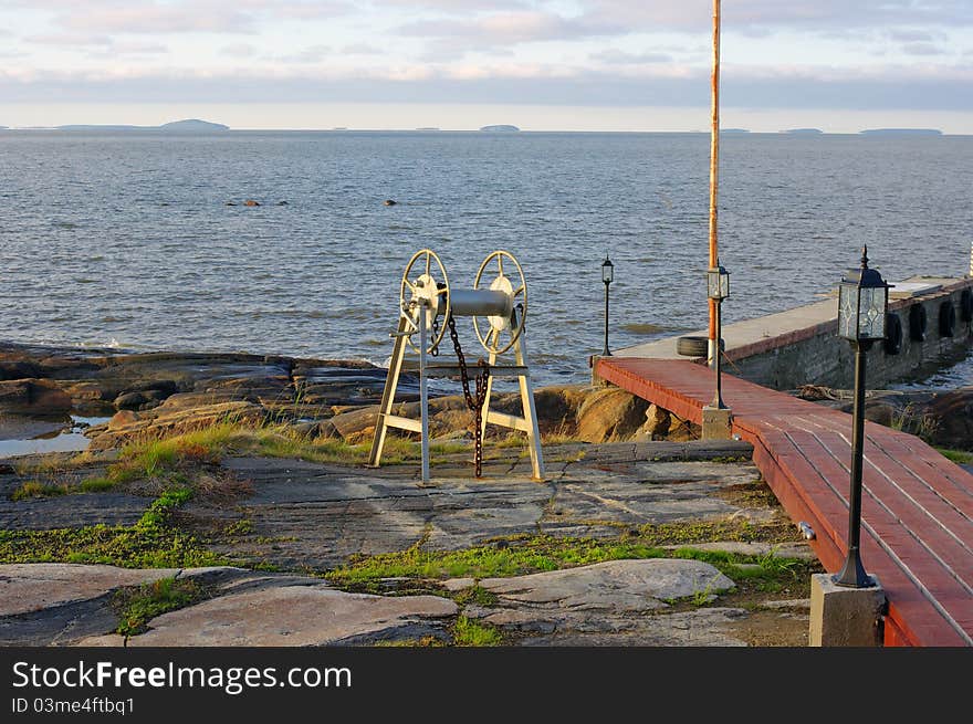 Marine dock and the islands on horizon at sunset