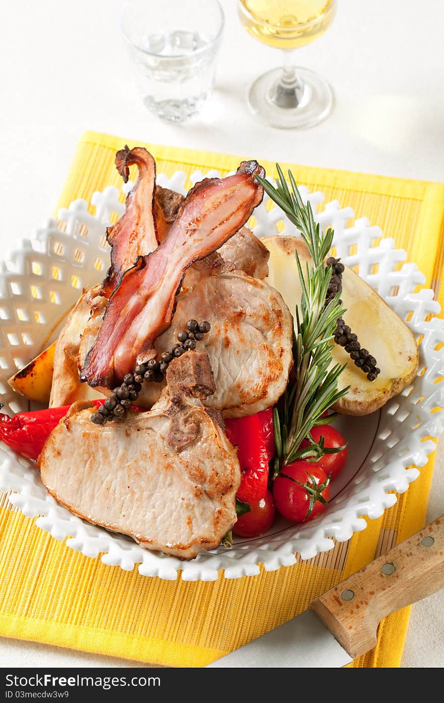 Roasted pork chops with  potato and red peppers