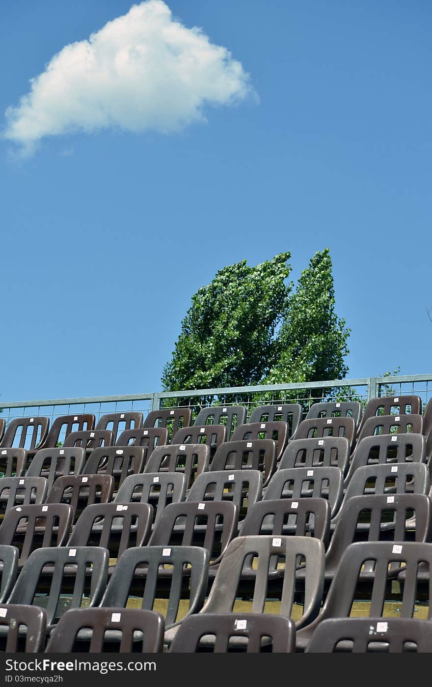 Tennis court empty places in a sunny day with fluufy clouds in the sky