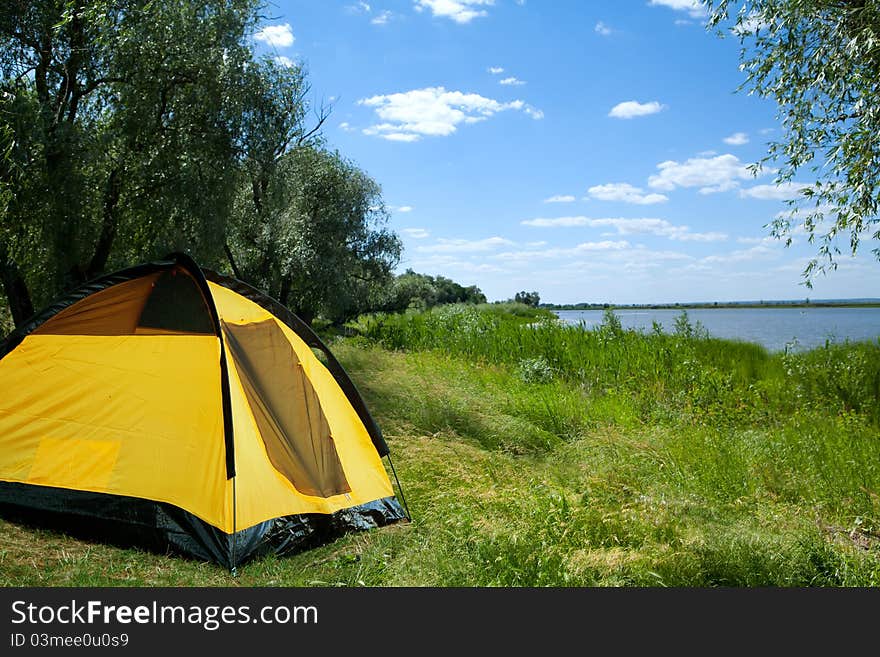 Tent yellow on the bank of lake. Tent yellow on the bank of lake