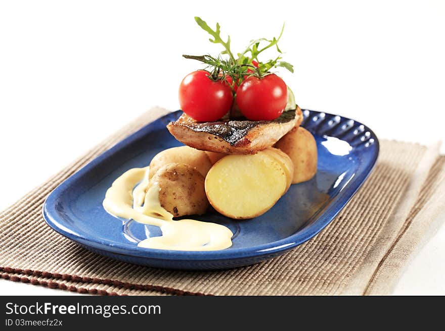 Pan fried trout served with new potatoes. Pan fried trout served with new potatoes