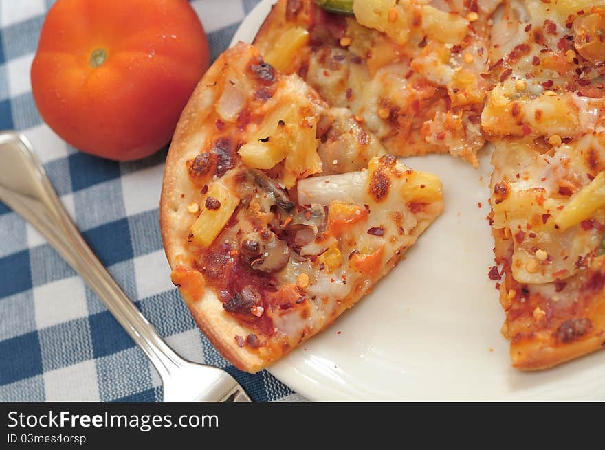 Sliced sumptuous vegetarian cheese pizza on white plate ready to be eaten. Topped with hot spices and herbs. Sliced sumptuous vegetarian cheese pizza on white plate ready to be eaten. Topped with hot spices and herbs.