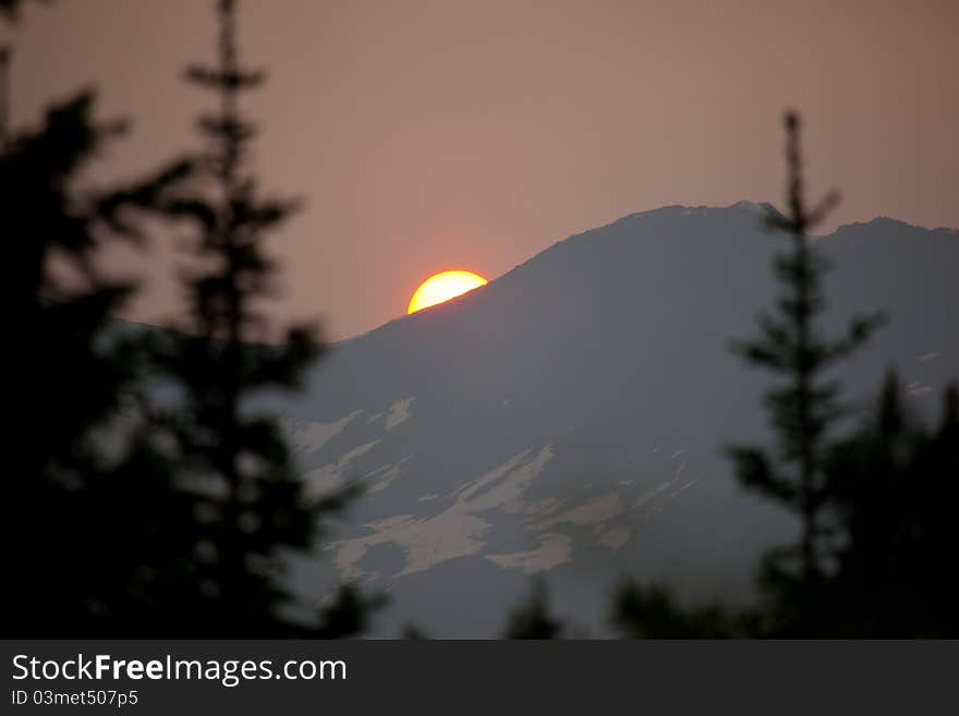 Sunset in mountains. There are some snow visible