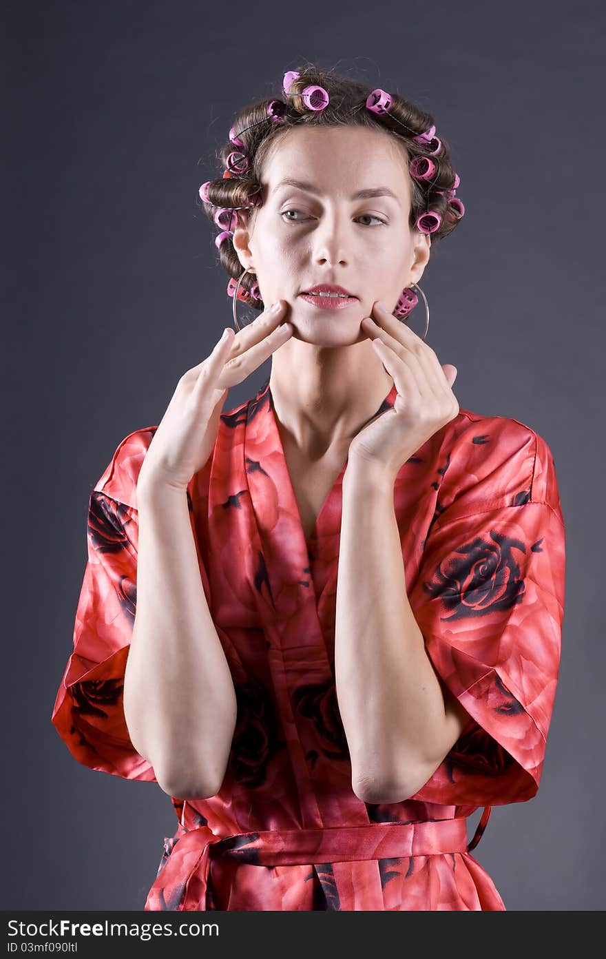 Beautiful young woman with bigoudi on the hair