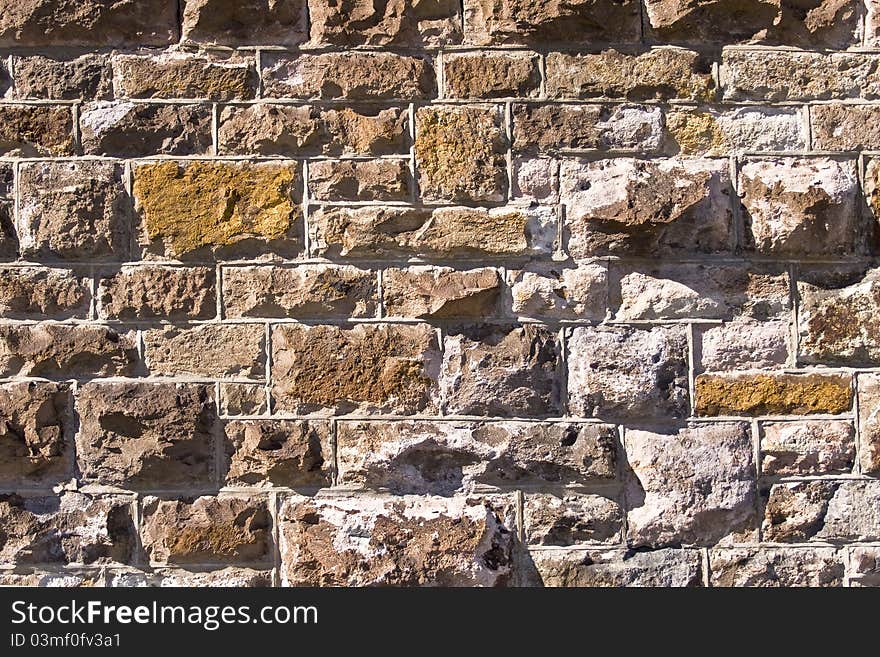 Old wall of stone with natural texture for a background. Old wall of stone with natural texture for a background