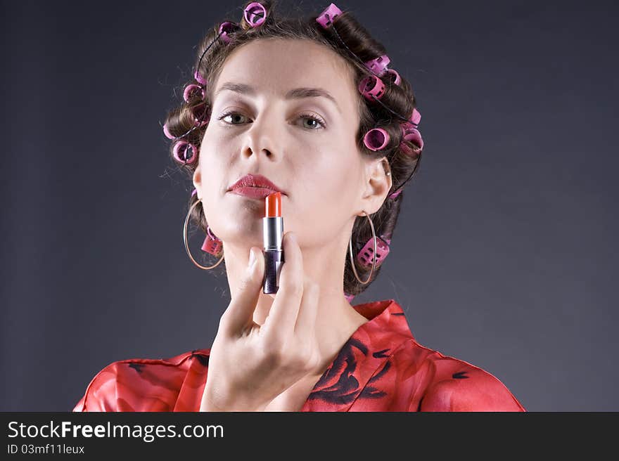 Beautiful young woman with bigoudi on the hair