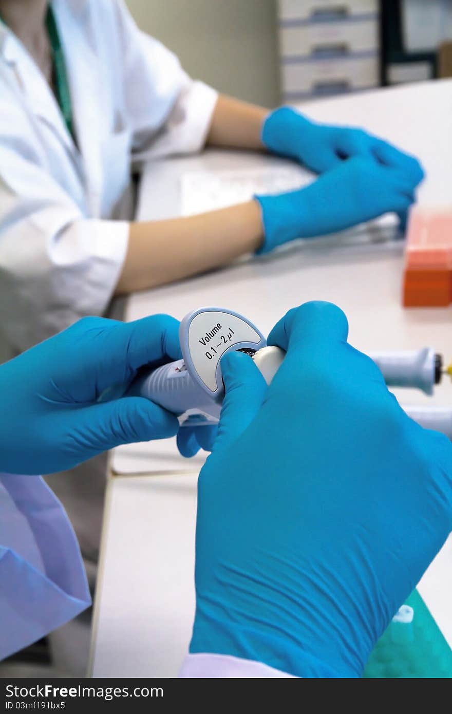 Researcher holding pipette in a science research lab