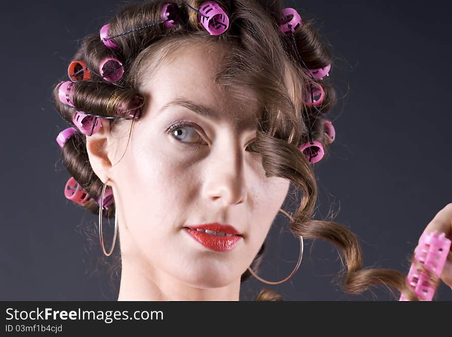 Beautiful young woman with bigoudi on the hair