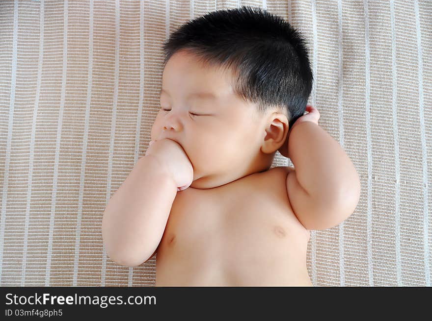 A 2 months chinese Baby girl lying on the bed. A 2 months chinese Baby girl lying on the bed