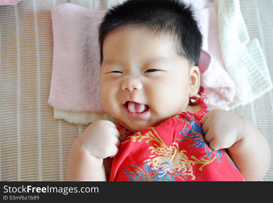 A 2 months chinese Baby girl lying on the bed. A 2 months chinese Baby girl lying on the bed