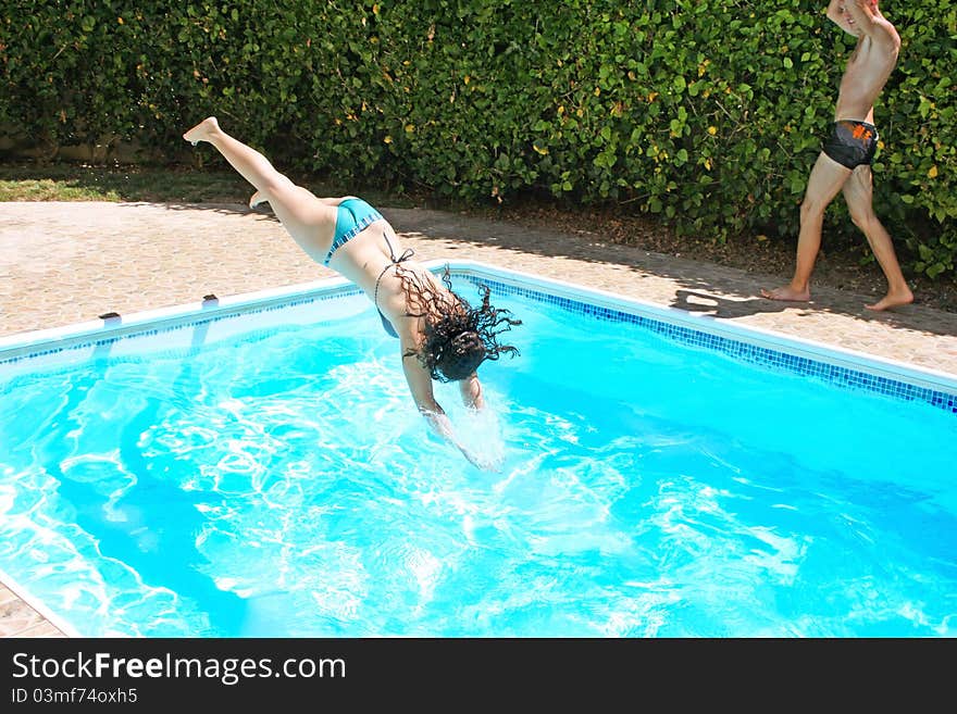 Pretty women jumping to swimming pool. Pretty women jumping to swimming pool.