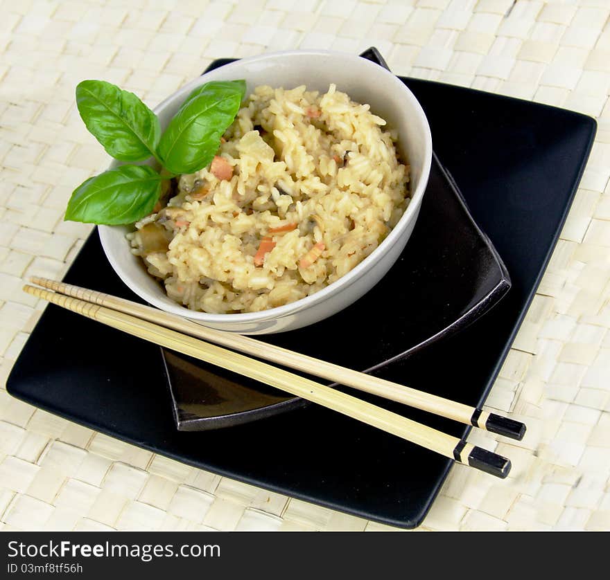 Vegetarian Risotto with Asian look and feel. Chopsticks and basil details. Vegetarian Risotto with Asian look and feel. Chopsticks and basil details.