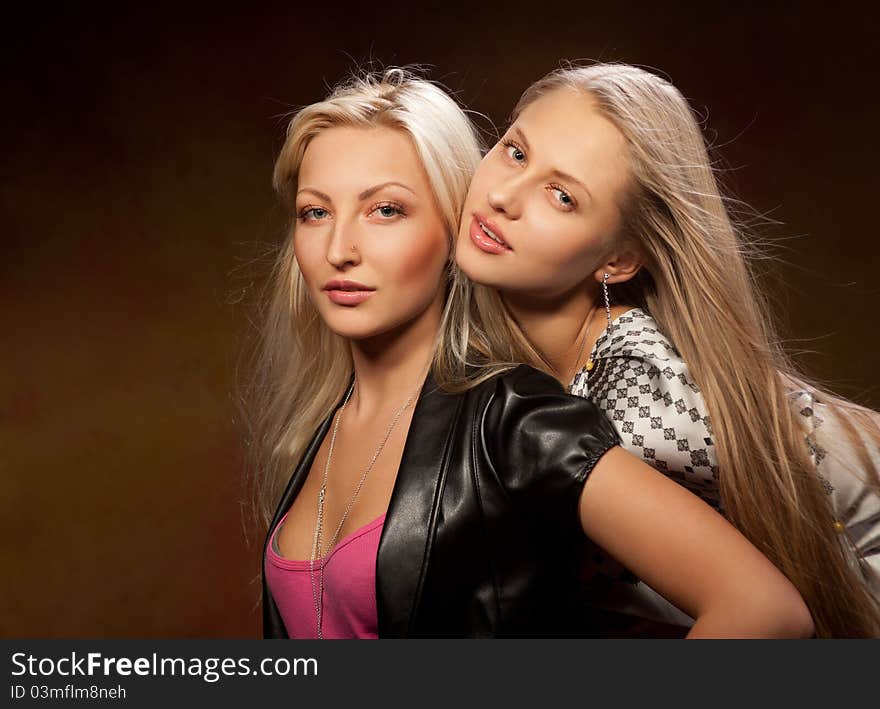 Two pretty women on a colored background