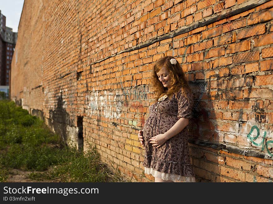 Full length of 9 months pregnant woman stands on street