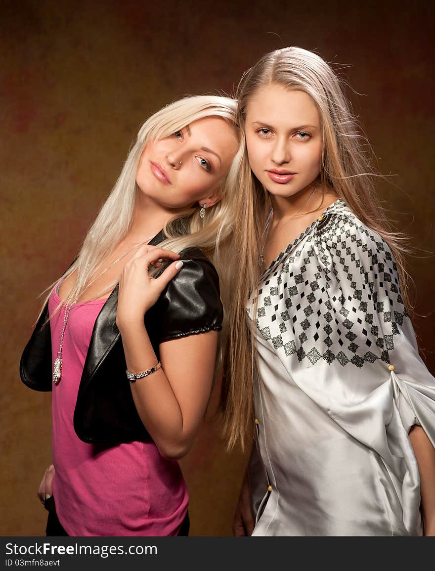 Two beautiful women on a colored background