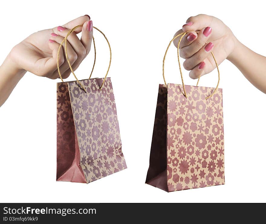 Woman hand holding shopping bags over white. Woman hand holding shopping bags over white