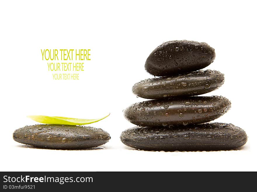 Isolated spa stones with a green leaf