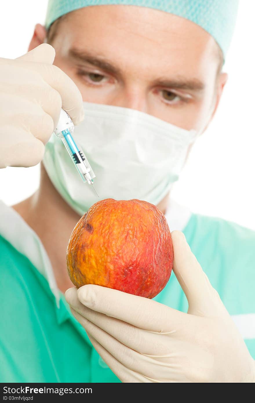 Man working with injection and apple. Man working with injection and apple