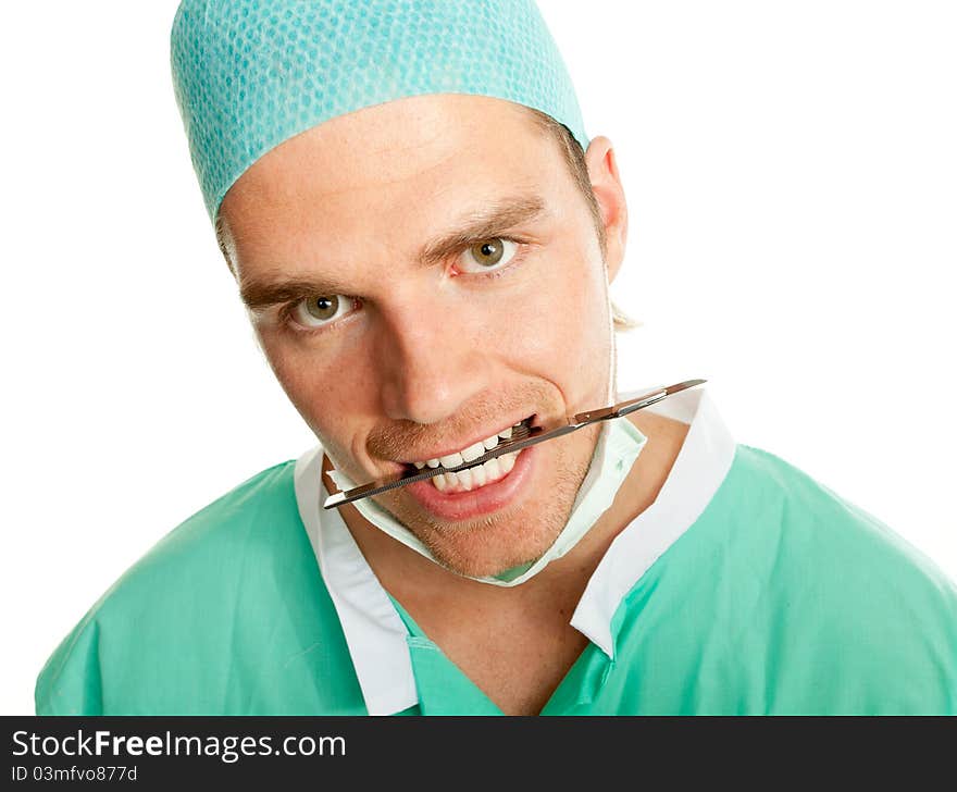 Crazy doctor with scalpel in his mouth