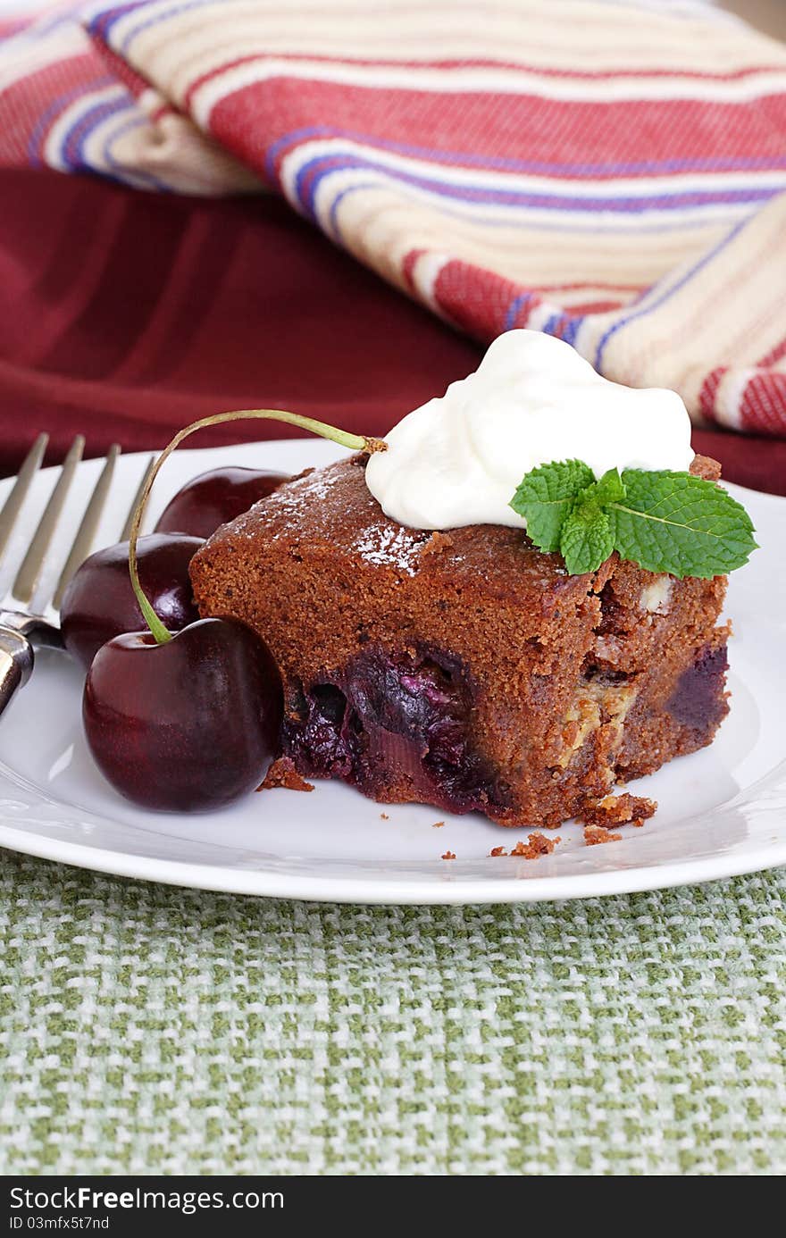 Cake baked with dark and white chocolate filled with fresh summer cherries. Cake baked with dark and white chocolate filled with fresh summer cherries