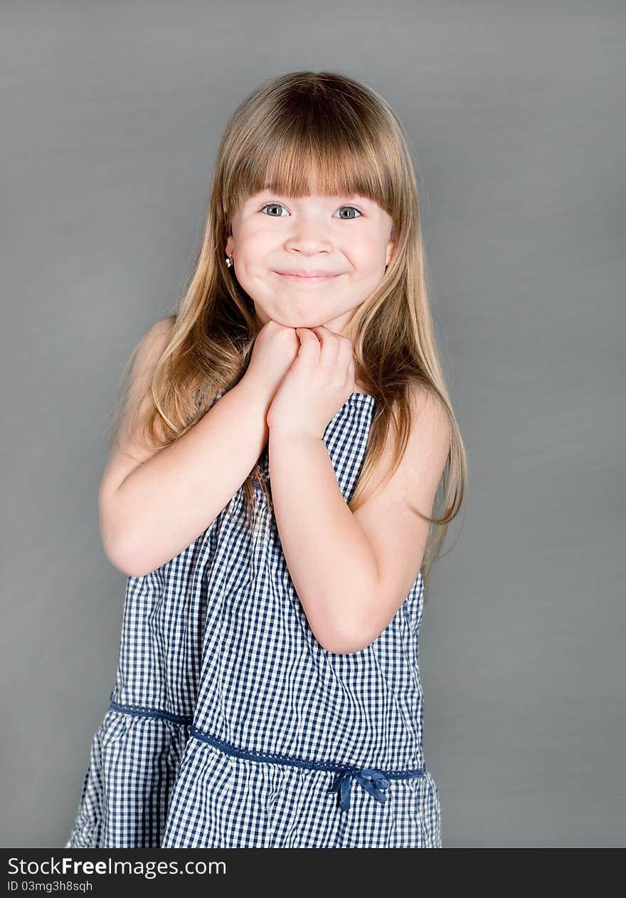 The Little Girl In A Dress Smiling With Surprise