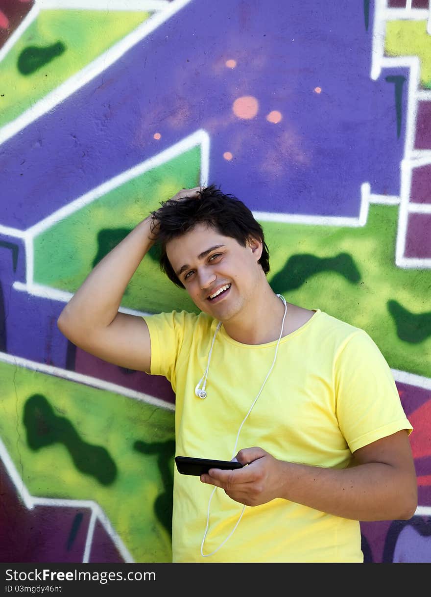 Teen near graffiti wall. Outdoor