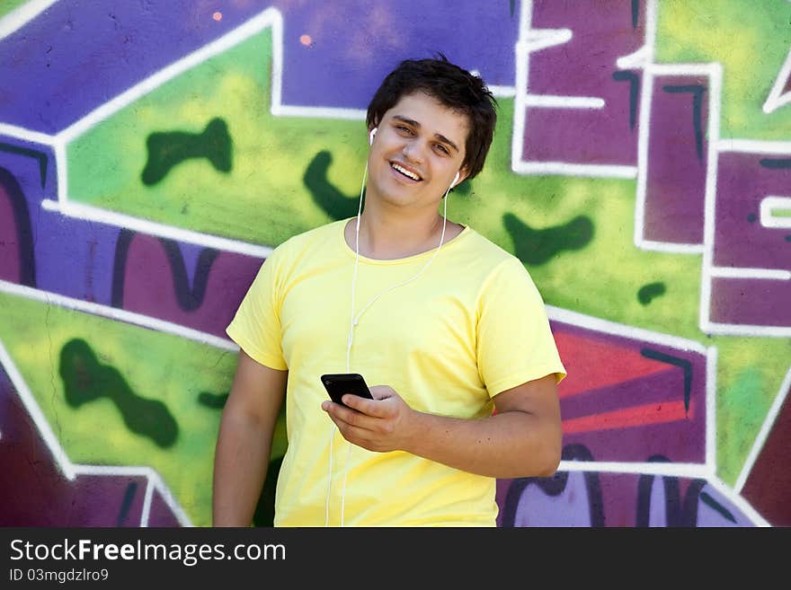 Teen near graffiti wall. Outdoor