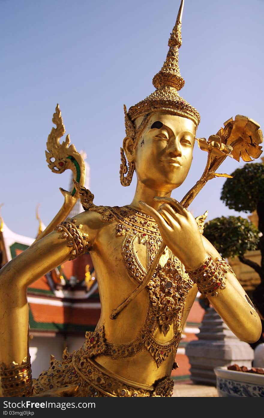 Gold sculpture Kinnari with flower in Royal palace. Bangkok, Thailand. Gold sculpture Kinnari with flower in Royal palace. Bangkok, Thailand