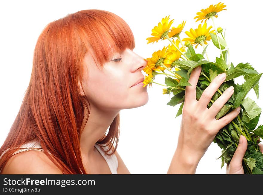 Attractive woman smelling yellow flowers. Attractive woman smelling yellow flowers