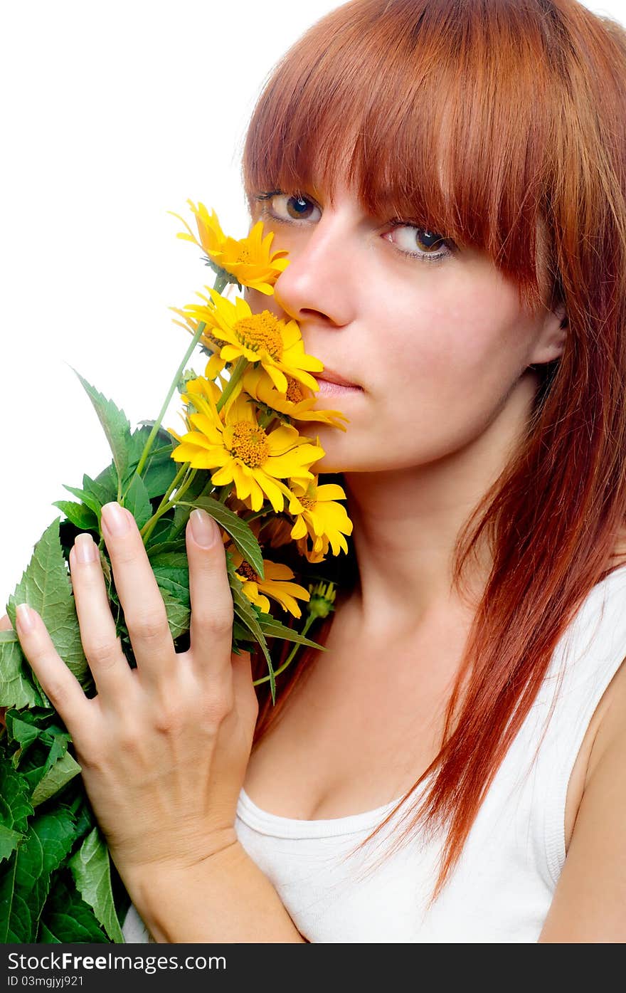 Attractive woman smelling yellow flowers. Attractive woman smelling yellow flowers