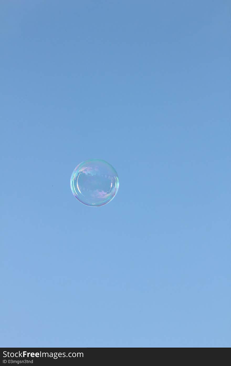 Bubble floating in the sky reflecting the sun and clouds. Bubble floating in the sky reflecting the sun and clouds