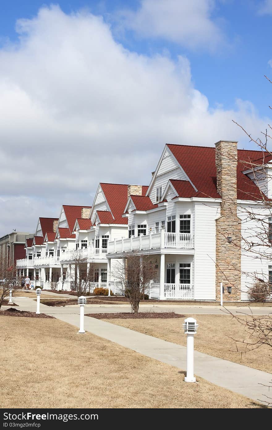 A row of white suburban townhomes. A row of white suburban townhomes