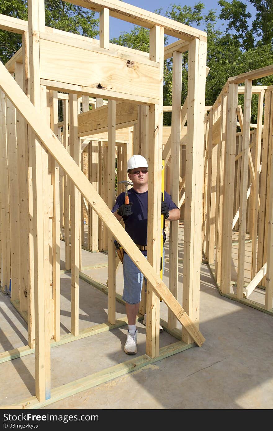 Carpenter inspecting walls for plumb, walls need to be very straight for door casing and windows