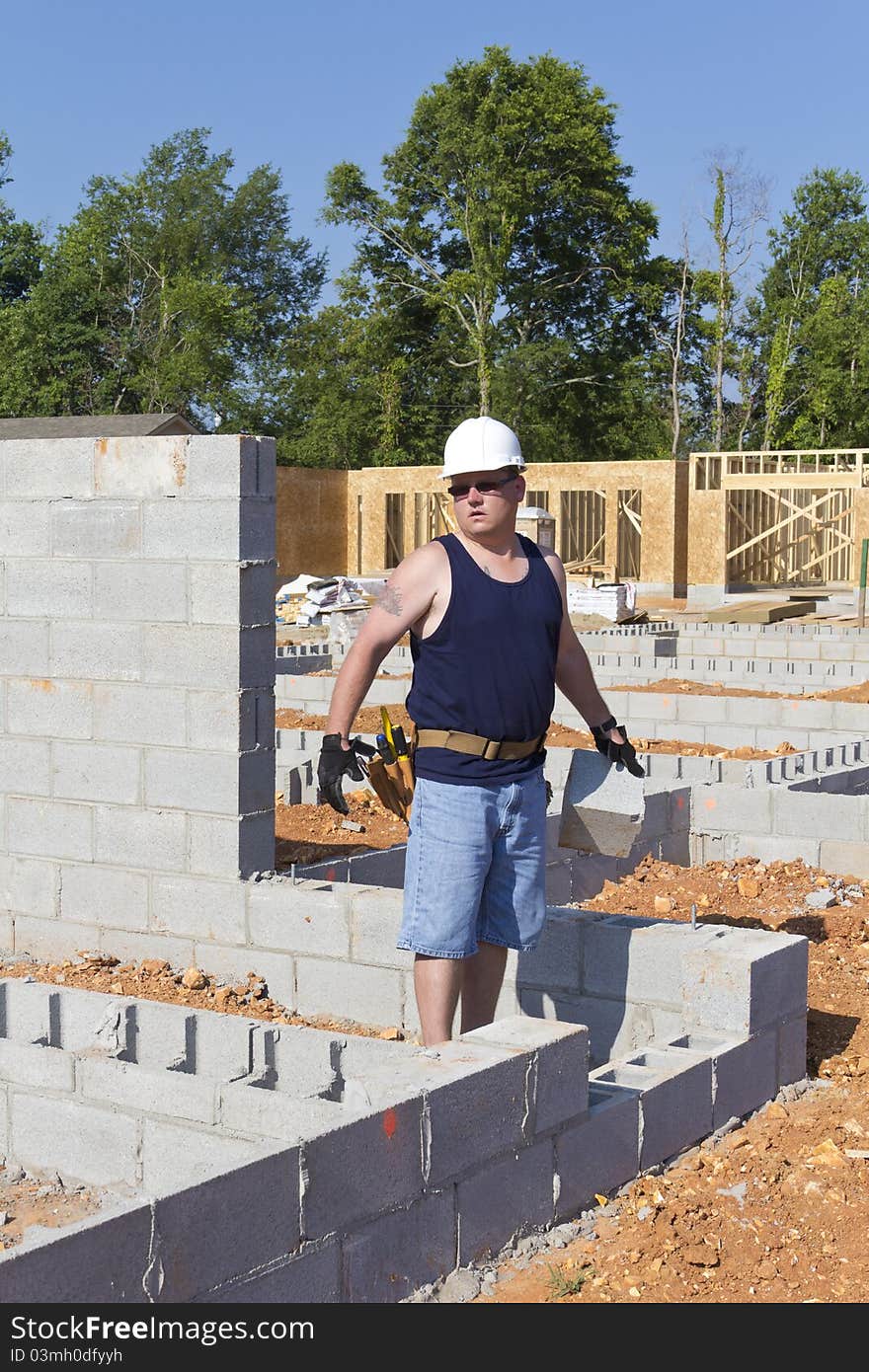 Mason with Concrete Block