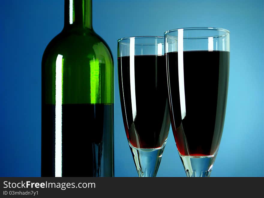 Bottle of wine and two glasses filled with wine. Bottle of wine and two glasses filled with wine