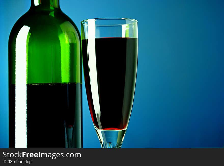 Wine Bottle And Glass On A Blue Background